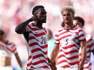 USA reach last 16 as Balogun scores but then sees red